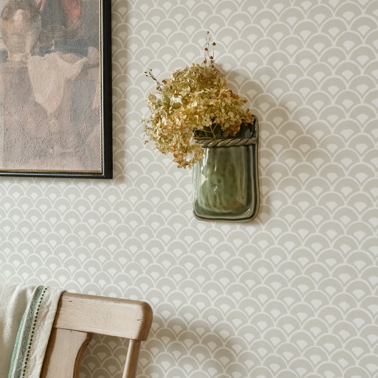Green Hale Ceramic Wall Vase shown styled on wall