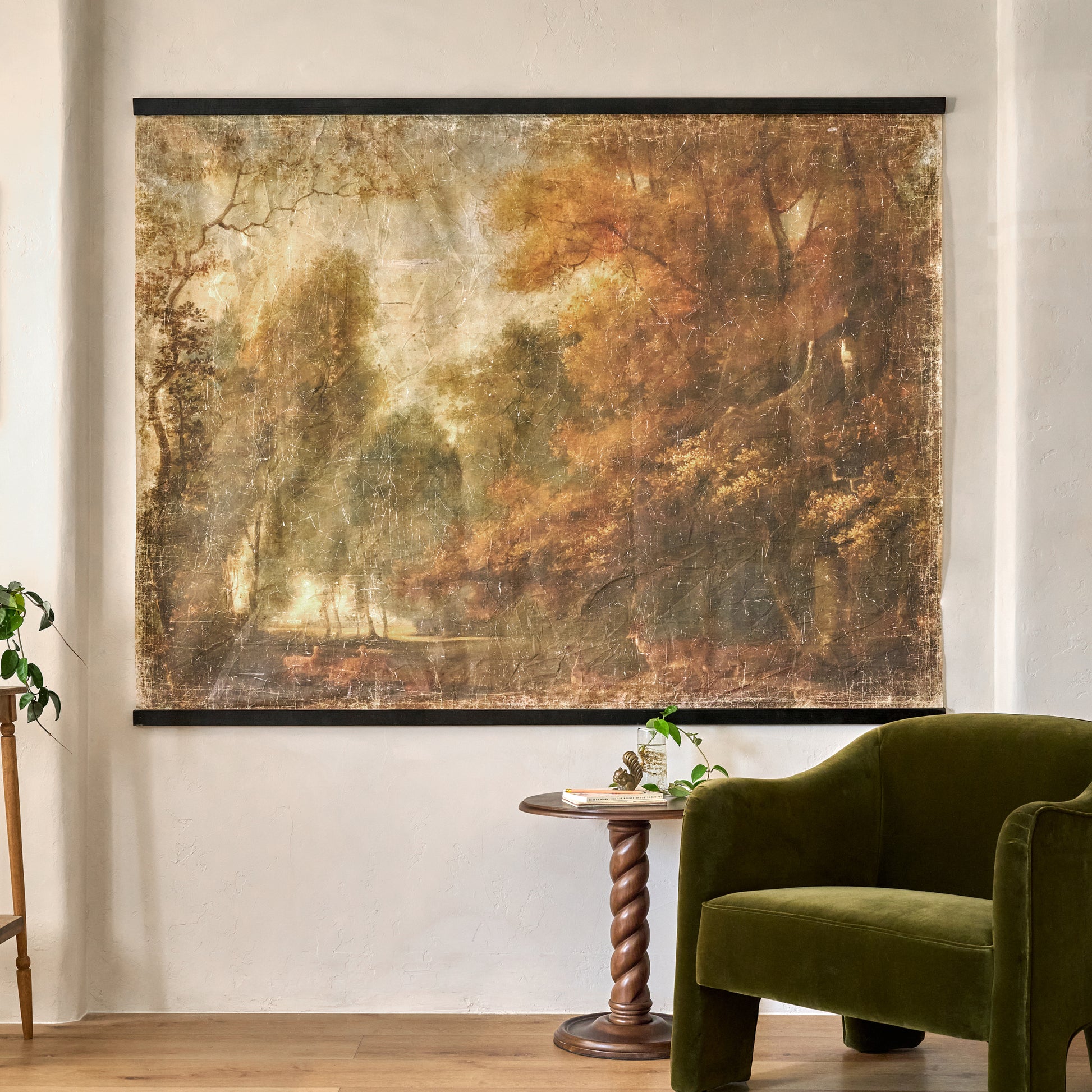 Oversized Enchanted Forest Tapestry shown hung on wall by accent chair