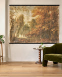 Oversized Enchanted Forest Tapestry shown hung on wall by accent chair