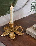Brass Holly Candle Holder with Handle shown with candle