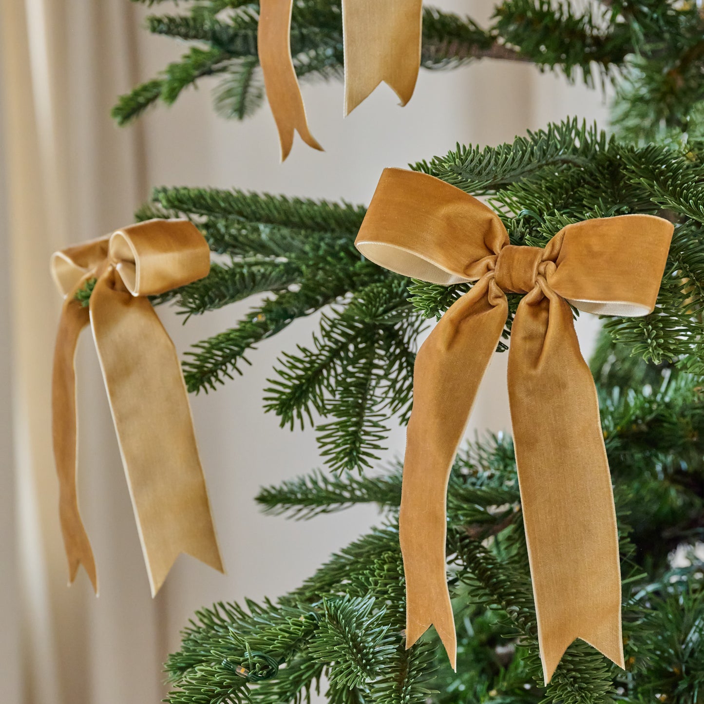 Amber Velvet Bow Ornament Clip, Set of 8 shown on tree