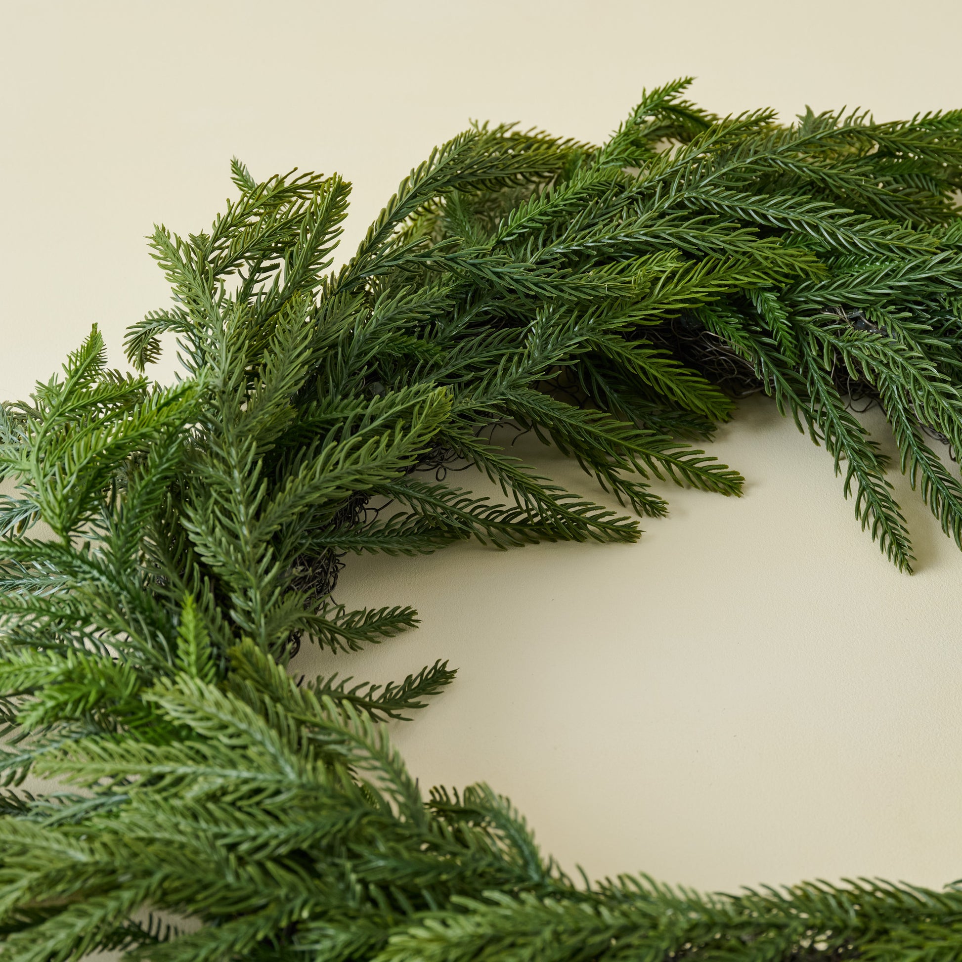 Close up of Real Touch Norfolk Pine Wreath showing lifelike quality
