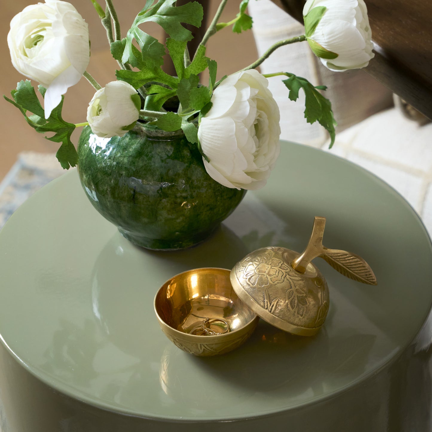 Antique Inspired Brass Apple Box displayed on green round end table