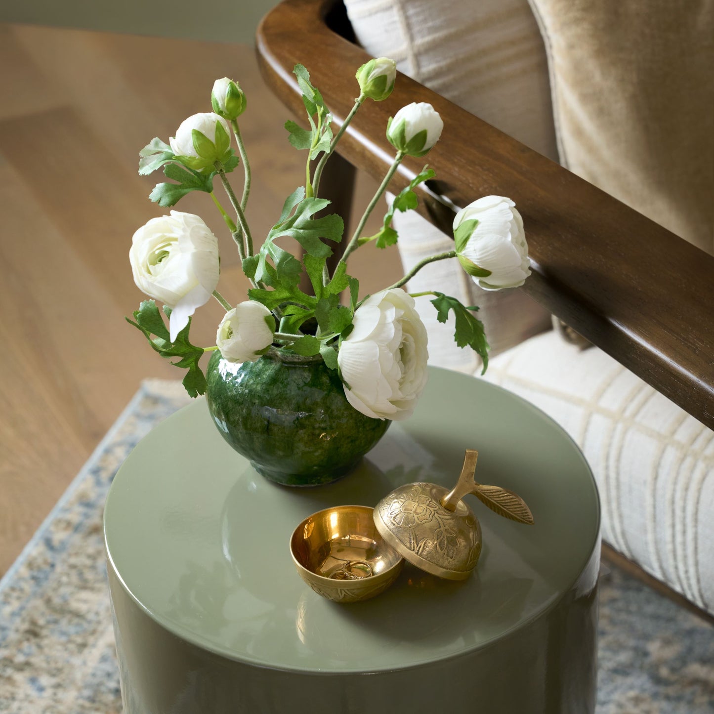 Round Blair Crackle Glaze Bud Vase with white ranunculus displayed on green end table