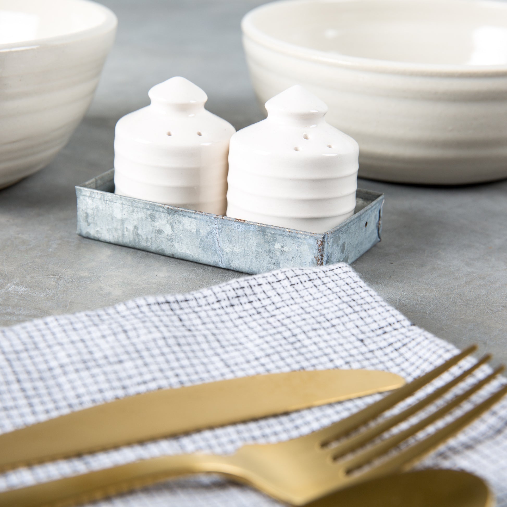 white ceramic salt and pepper shaker set shaped like silos in galvanized tin tray set