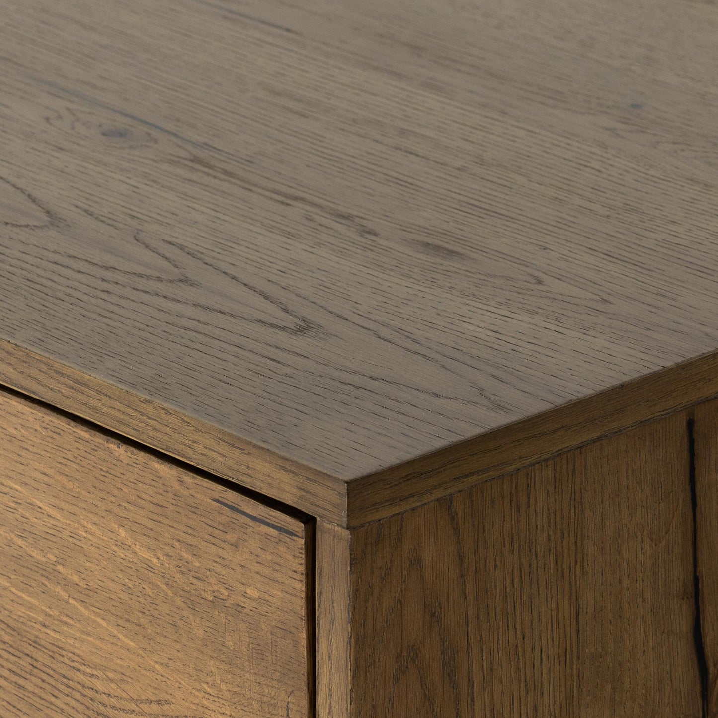 Liam 5 Drawer Dresser in amber oak close up of corner