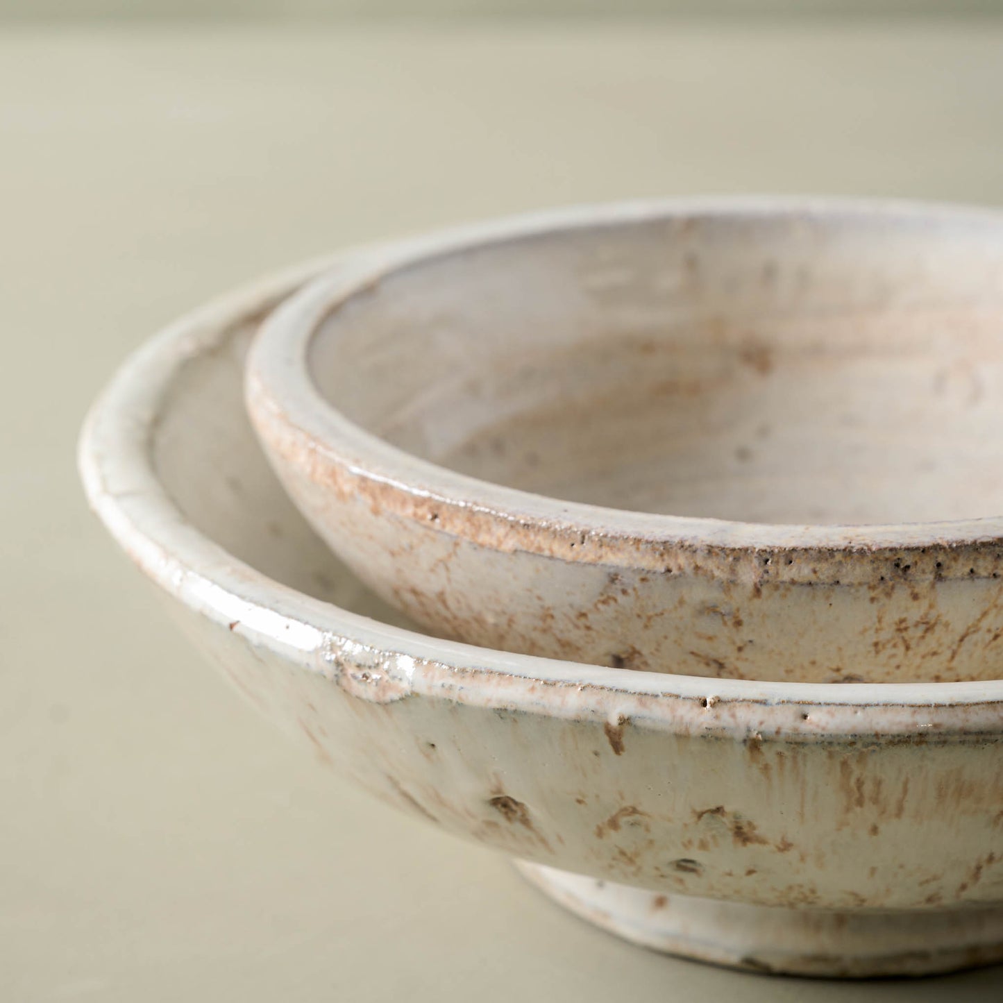 Close up of Rustic cream accent bowls stacked together