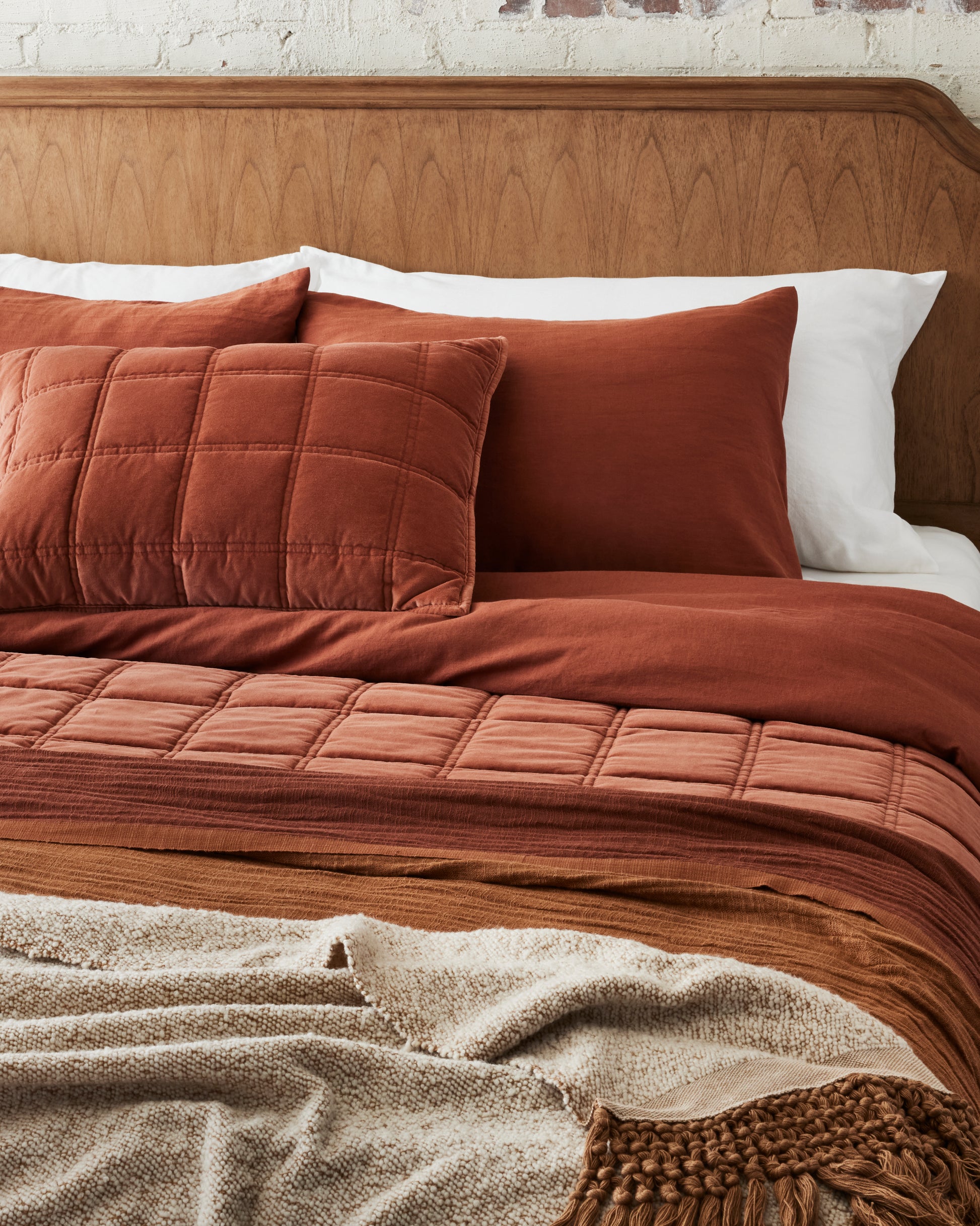 adobe tassel throw at the foot of bed