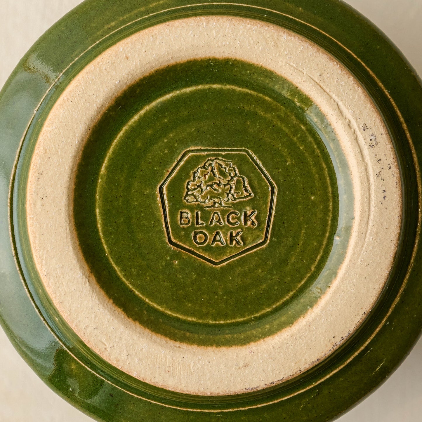 Magnolia Established Mug - Green close up of bottom of mug with black oak logo