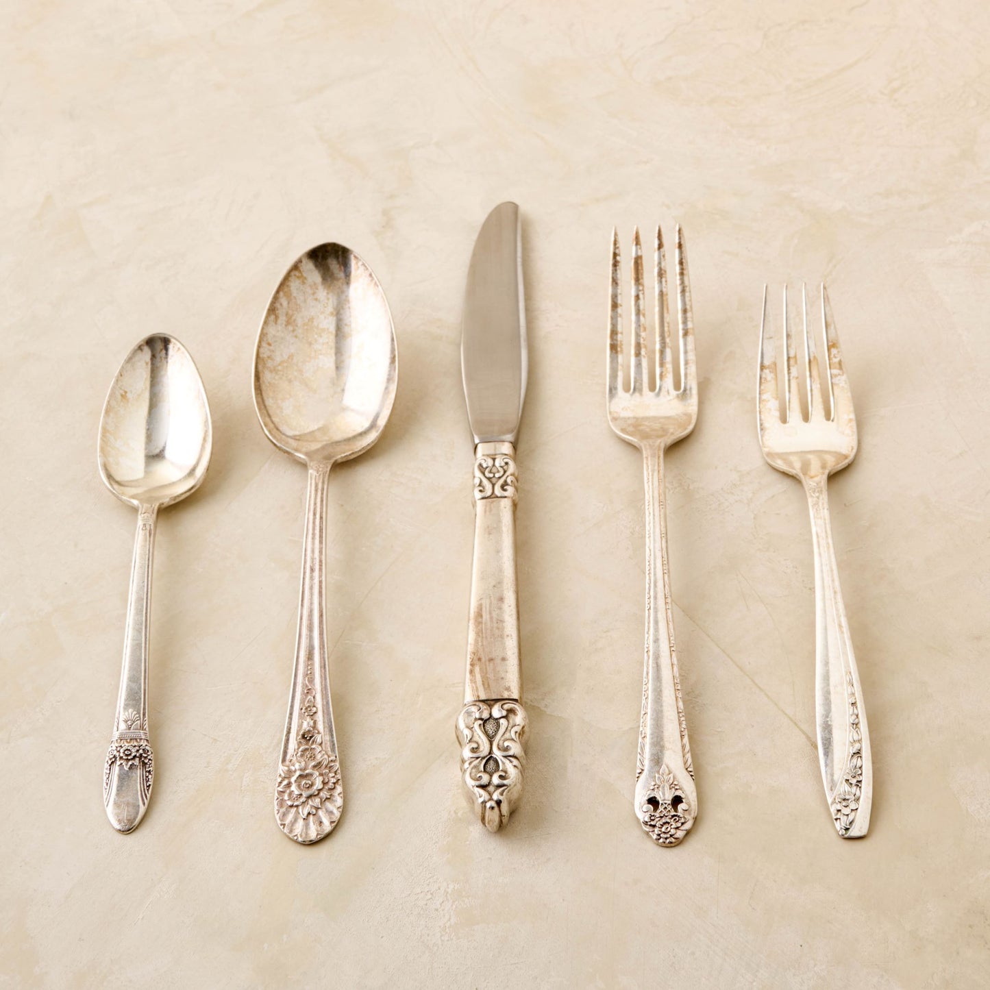 magnolia vintage flatware set including fork, knife, and spoon