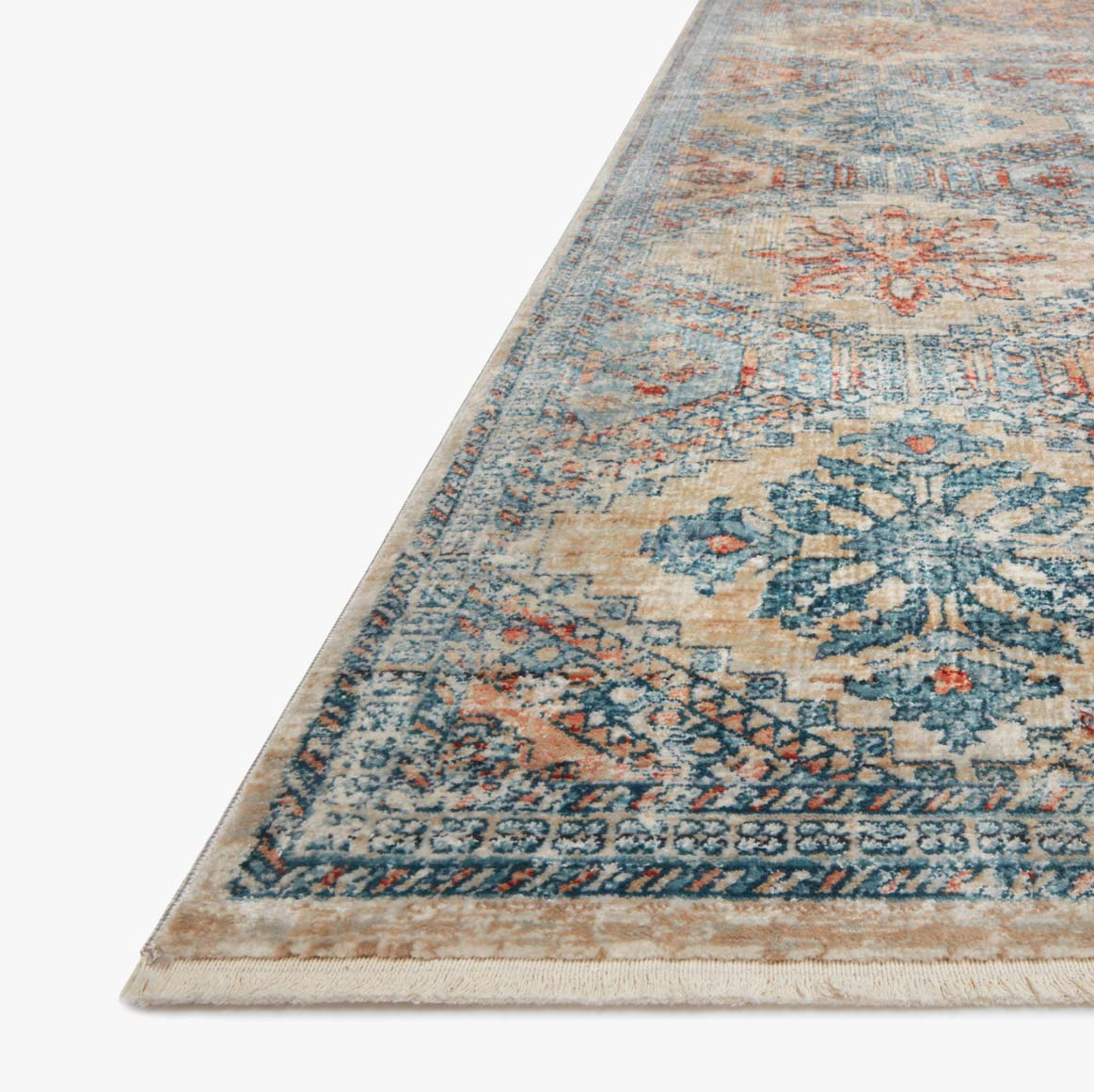 blue, orange, and tan diamond patterned rug with floral detail