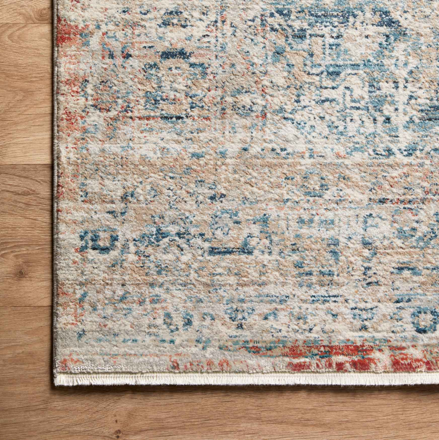 distressed multi-colored traditional area rug with floral detail