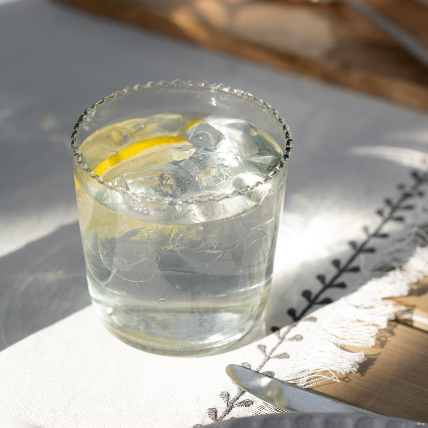 Elizabeth Bottle Cut Glass Tumbler in small size with iced water and lemon