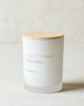 magnolia fresh start candle with wood lid notes scents of grapefruit salt and mineral