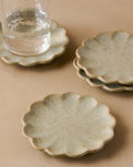 Scalloped Edge Stoneware Coaster Set pictured with rustic glass on coaster