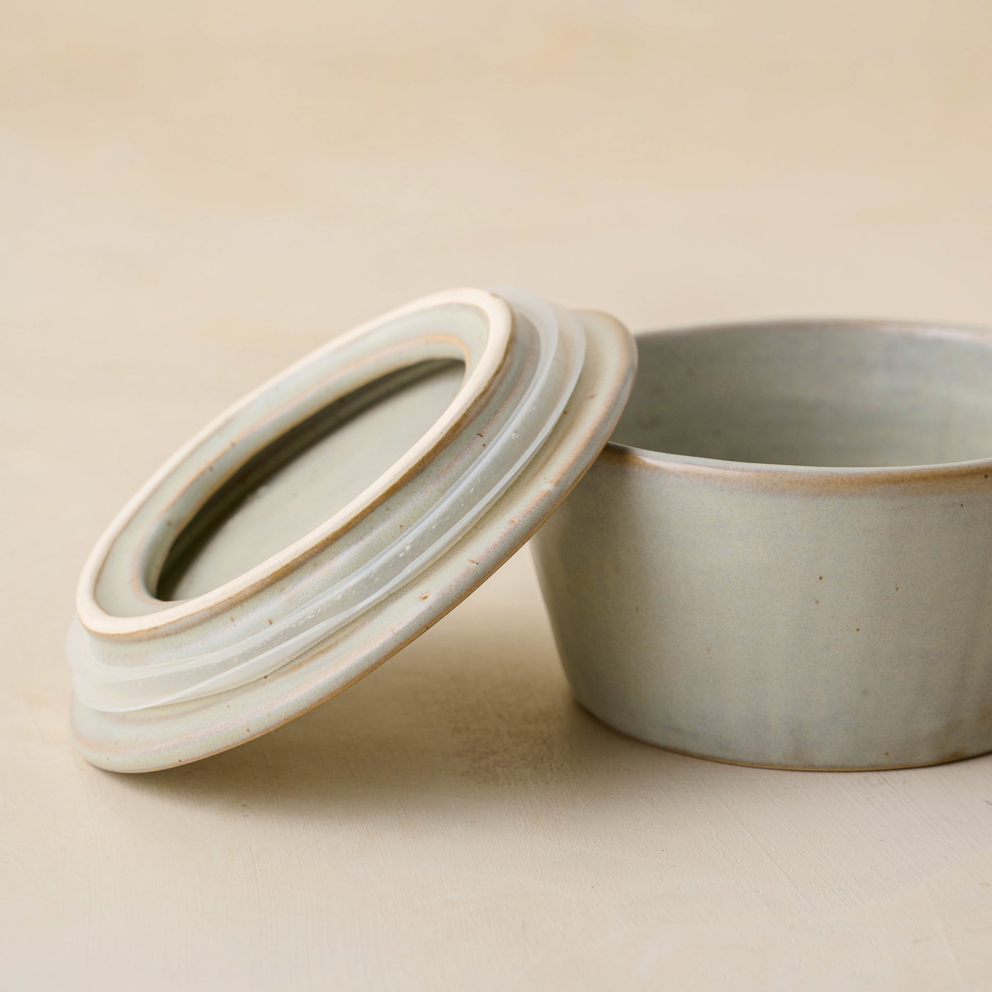 French Grey Ceramic Food Storage Bowl with top leaning against bowl