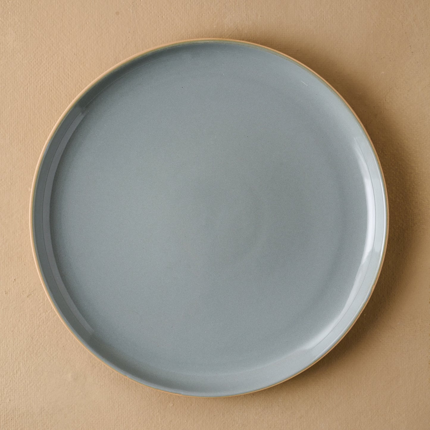 Lakelynn plate with a glazed blue gray interior and a tan exterior in dinner plate size