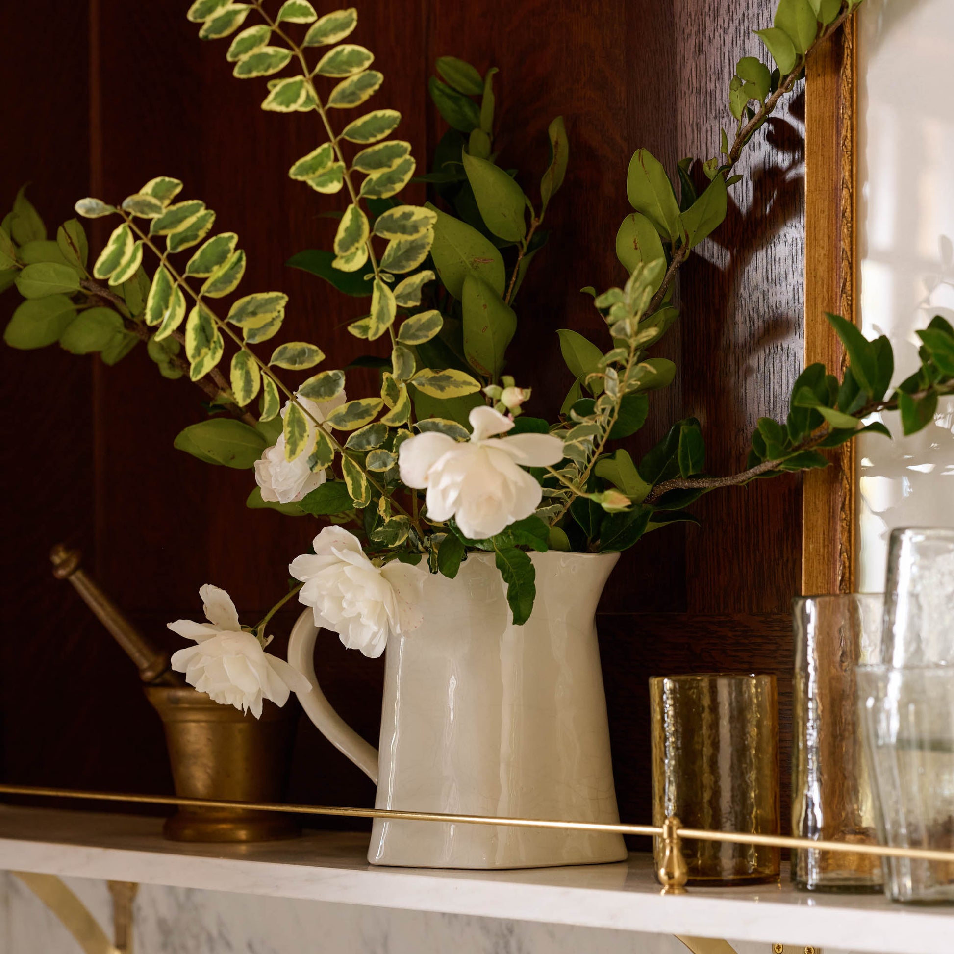 Vintage-Inspired Crackle Pitcher on a shelf containing flowers