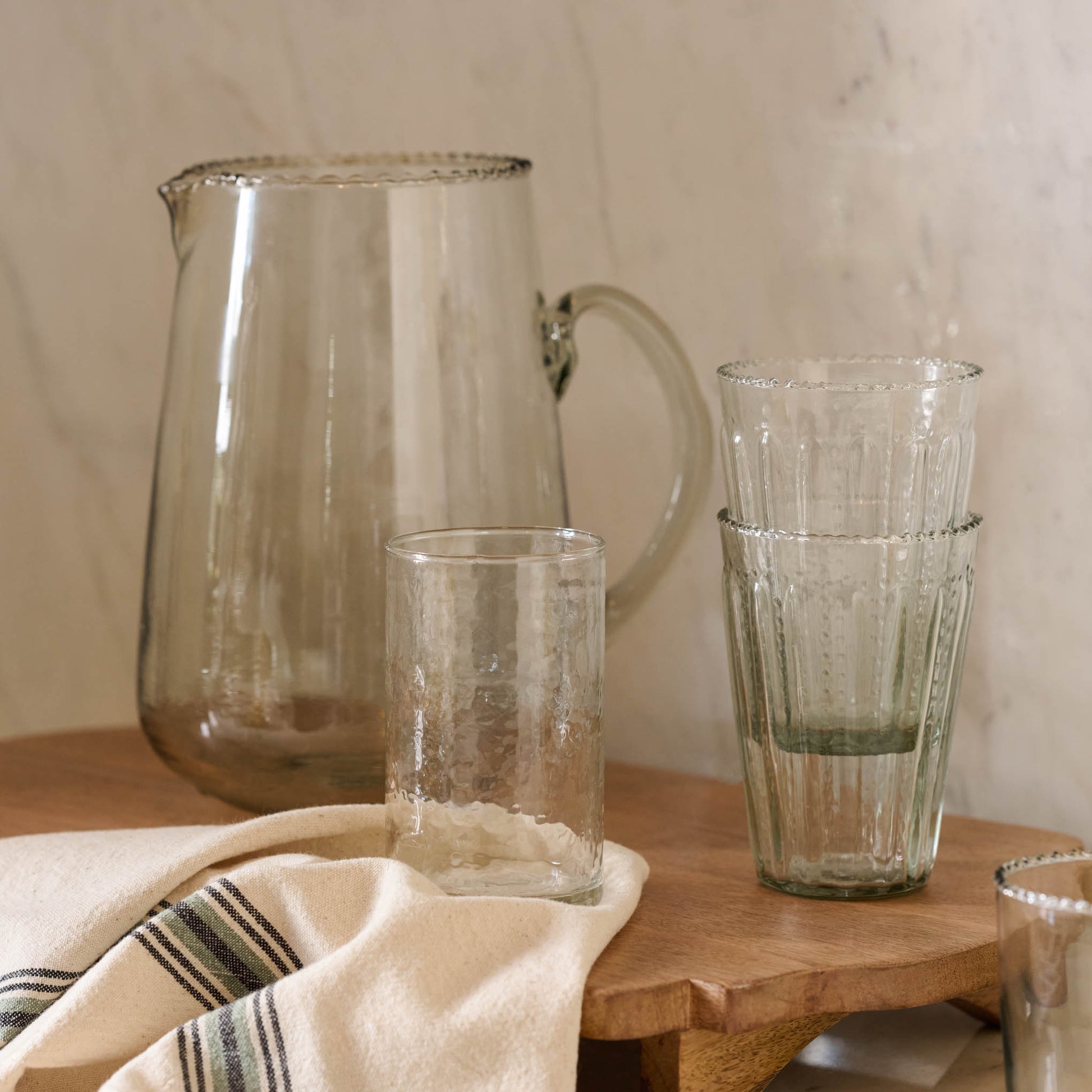 Rustic Glass Tumbler on serving board with elizabeth bottle cut pitcher and tumblers