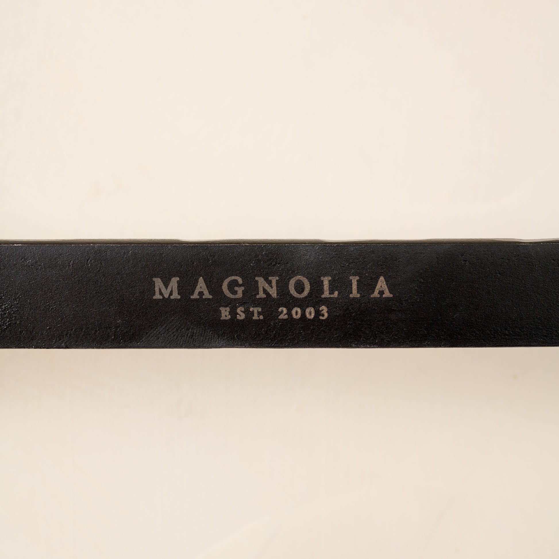 Close up of magnolia brand on wall hook.
