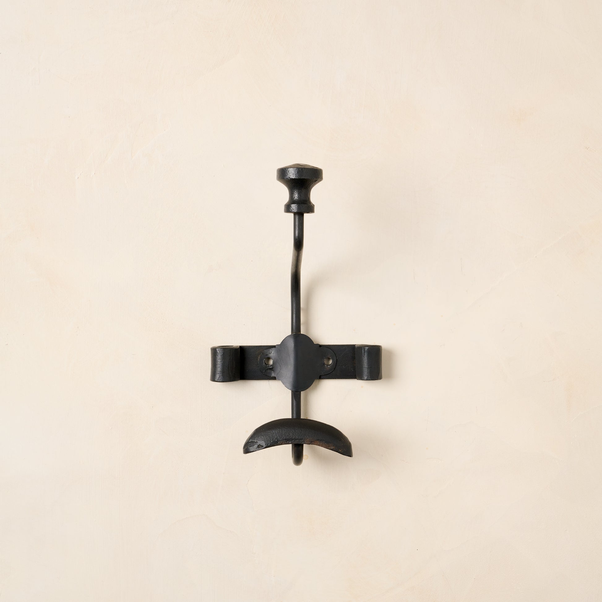 Close up of single duke metal wall hook.