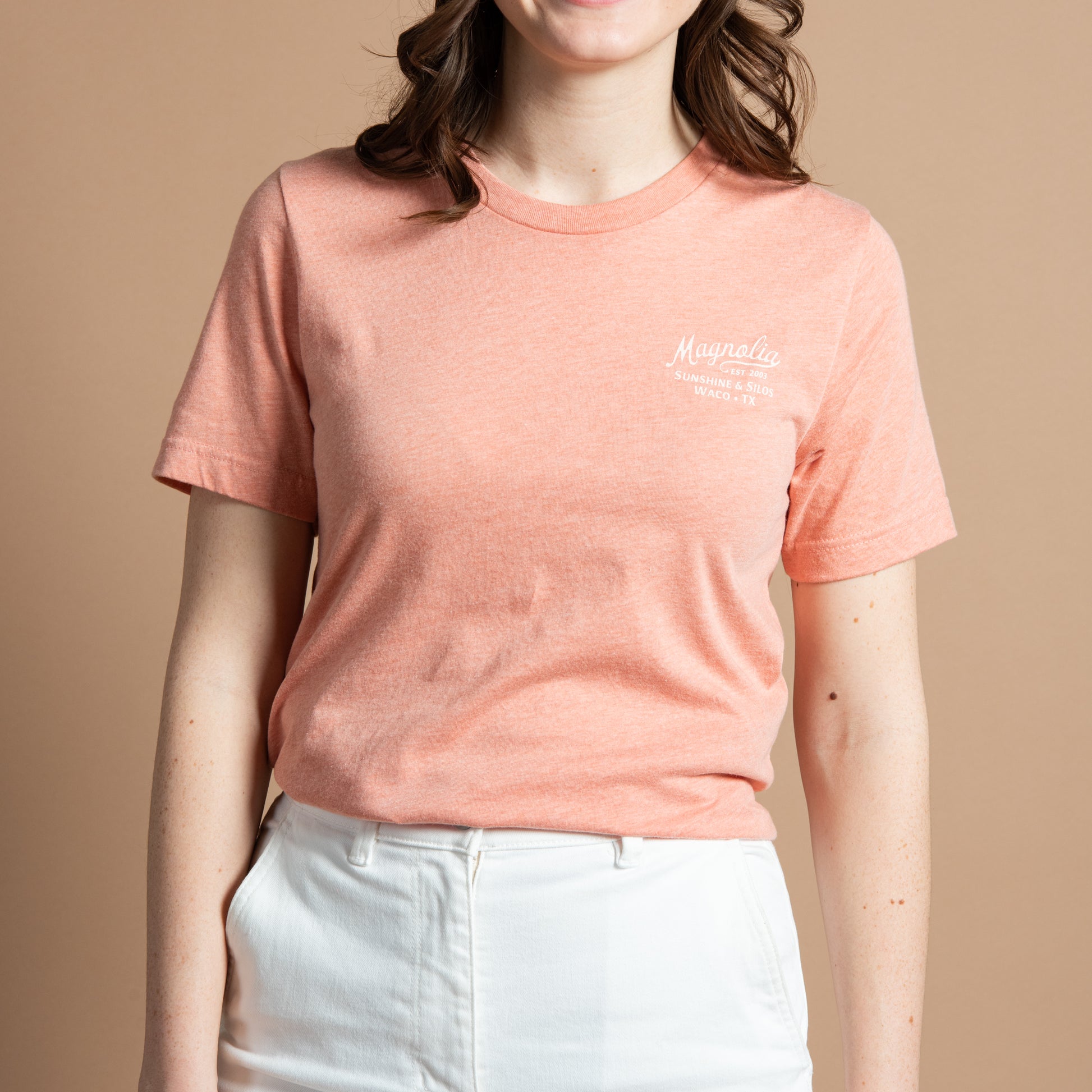 pink-coral t-shirt with "magnolia est 2003" in a cursive script font