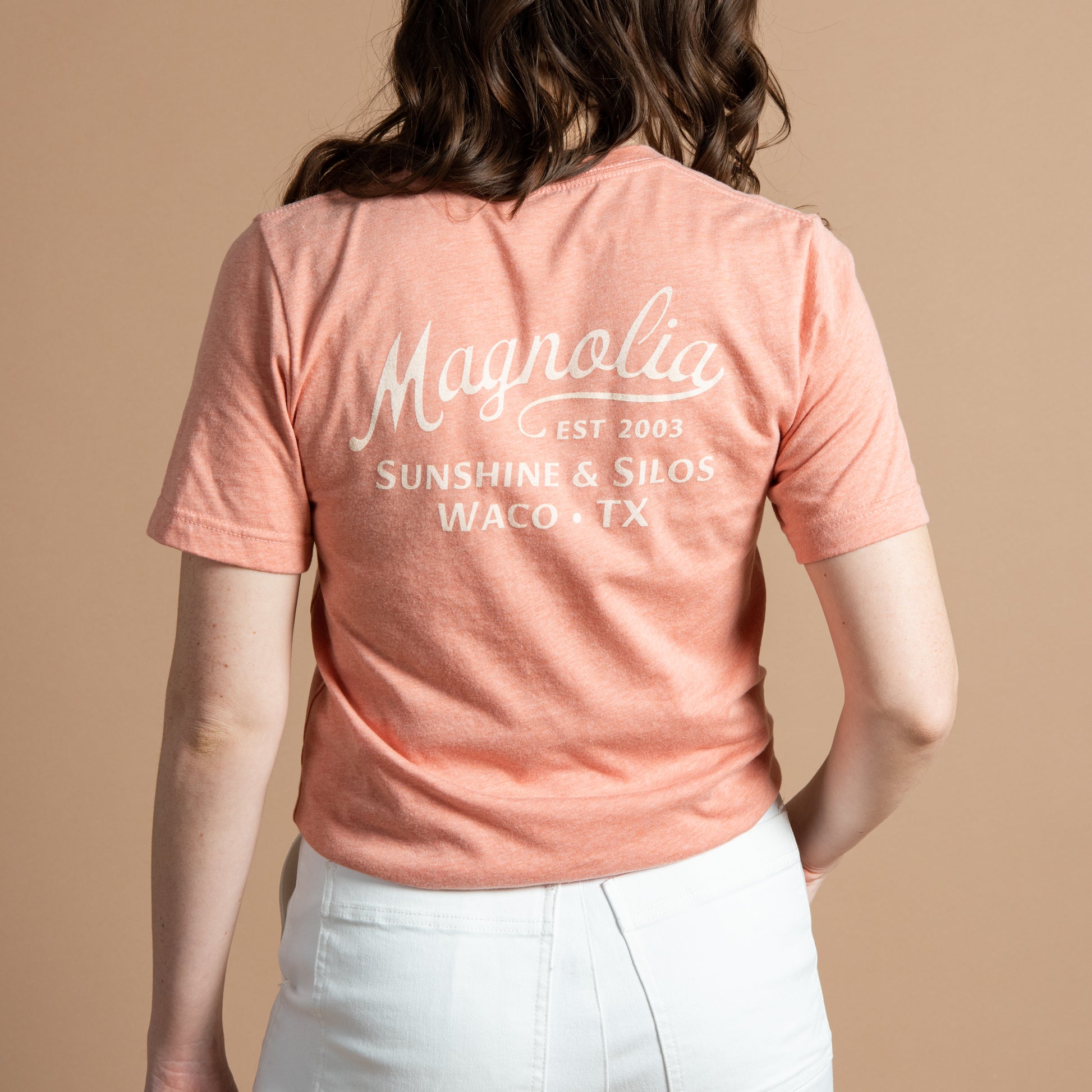 pink-coral t-shirt with "magnolia est 2003" in a cursive script font