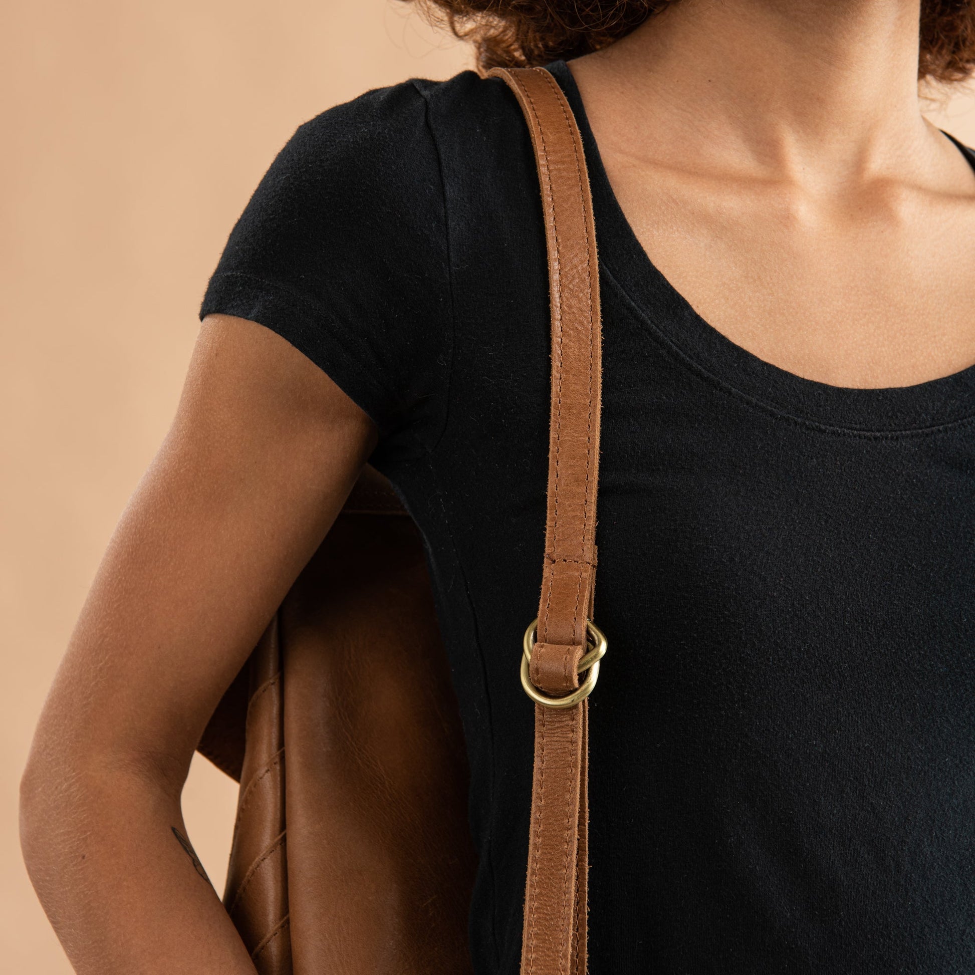 brown leather backpack with herringbone pattern stitching