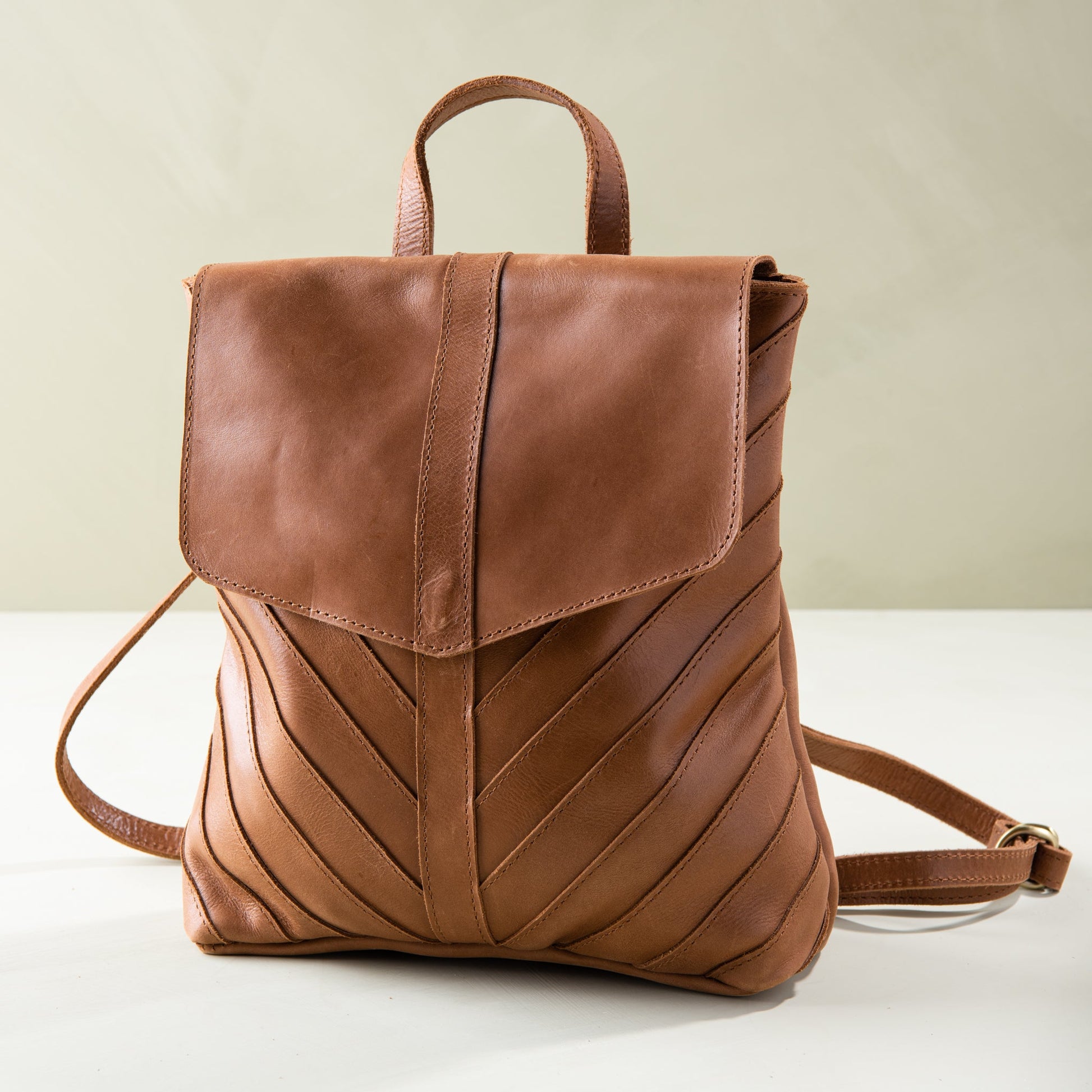 brown leather backpack with herringbone pattern stitching