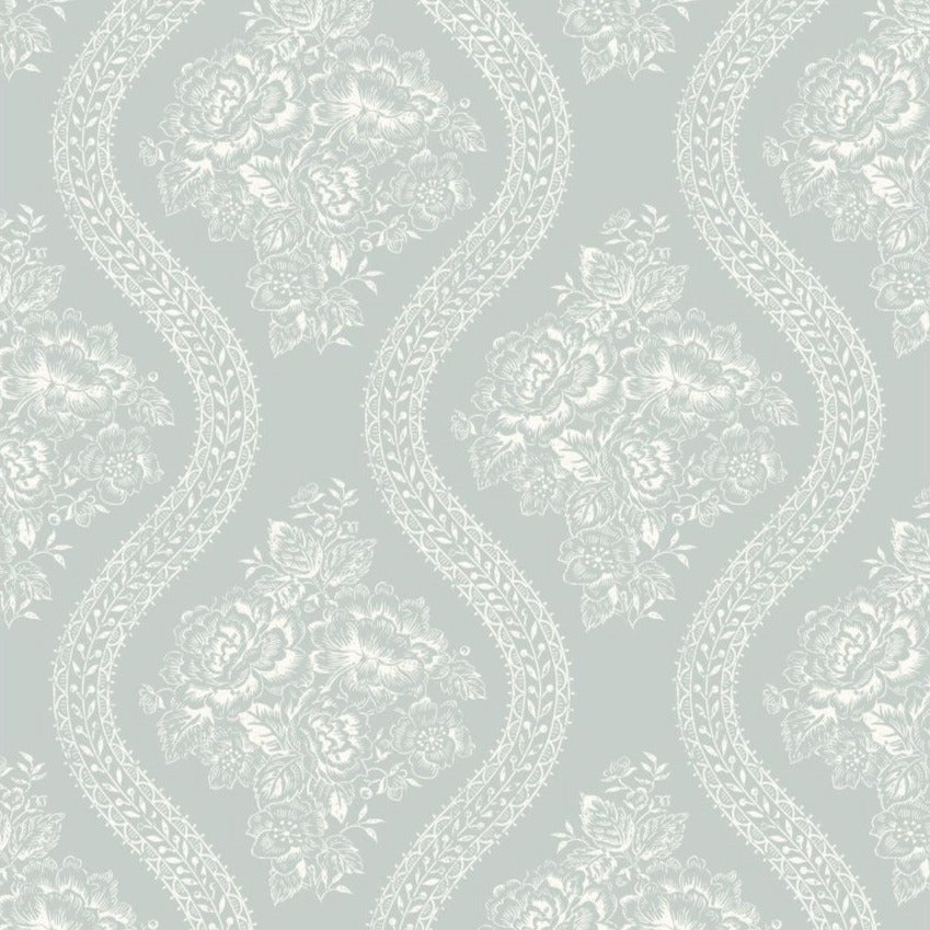 white floral pattern on muted blue wallpaper