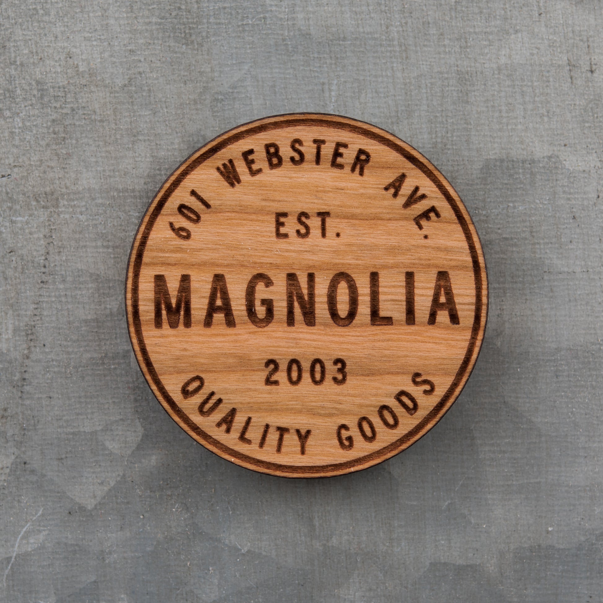 laser engraved wooden magnet with Magnolia circle crest logo