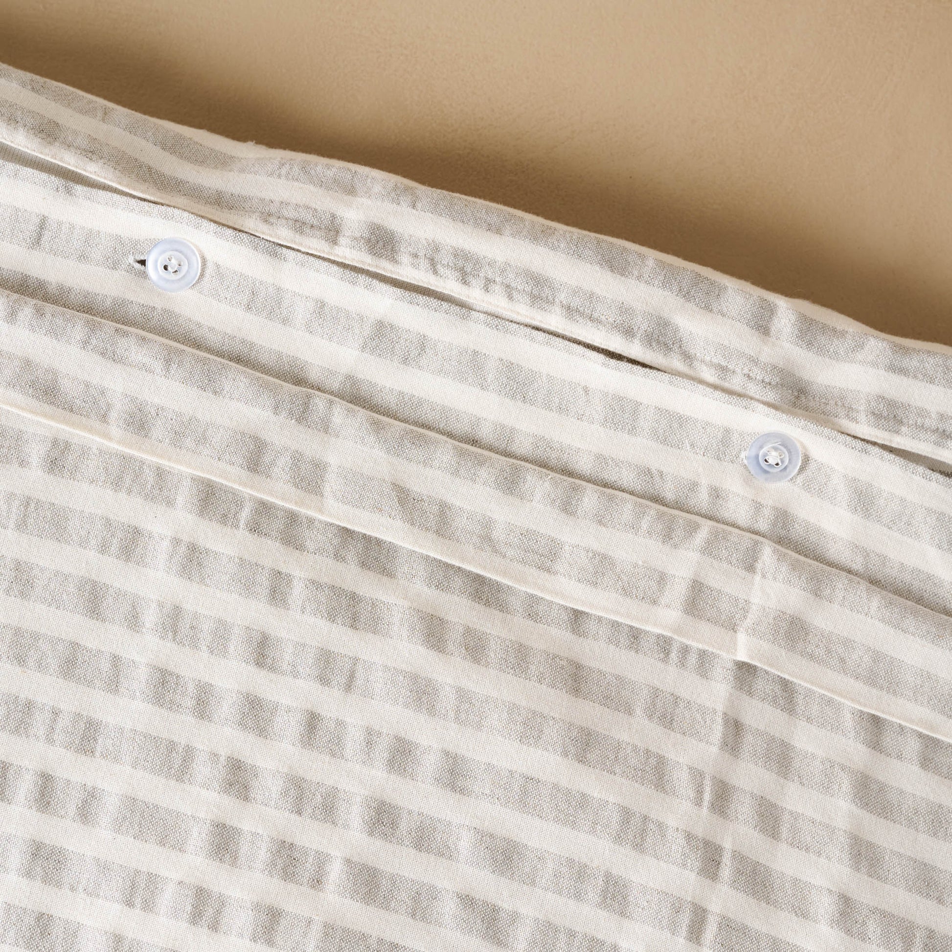 Shadow Grey + Oatmeal Stripe Linen Cotton Duvet close up of buttons on duvet
