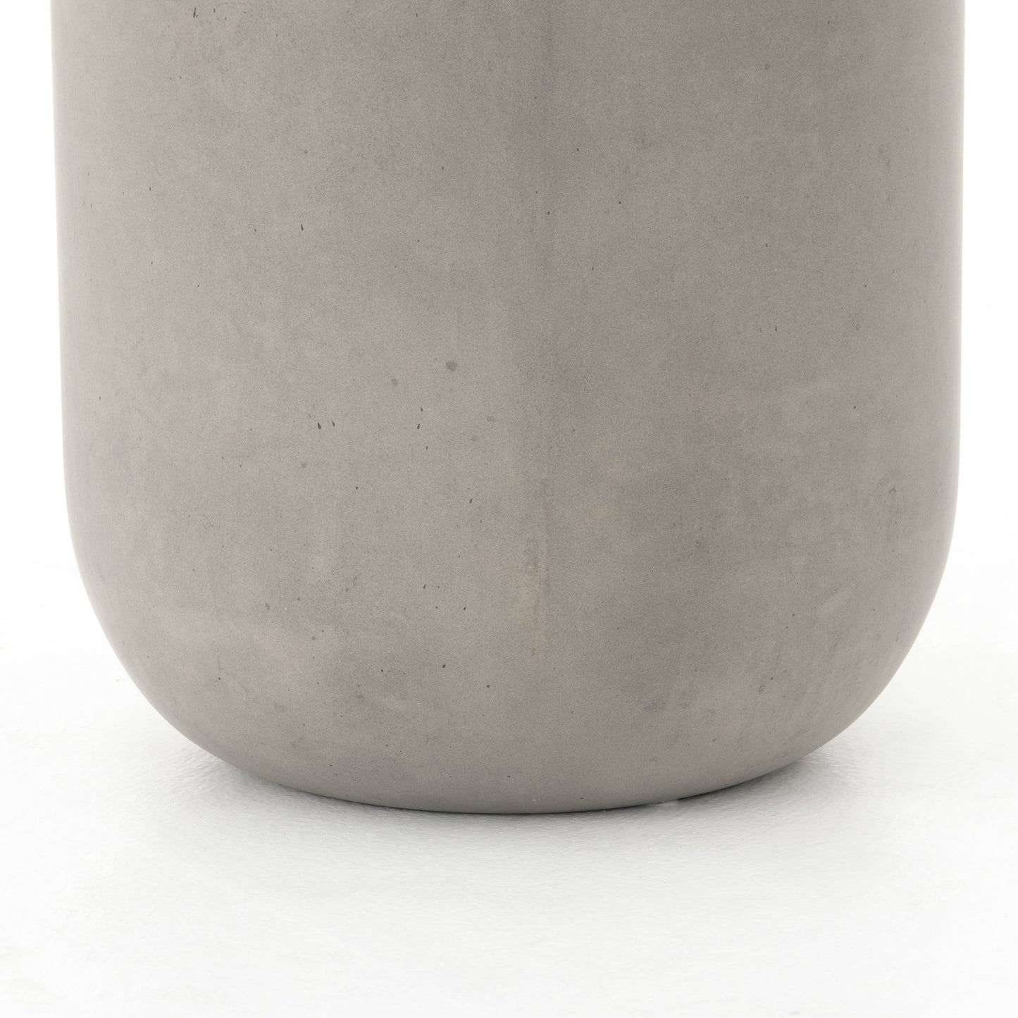 modern grey cylindrical end table with plaster finish