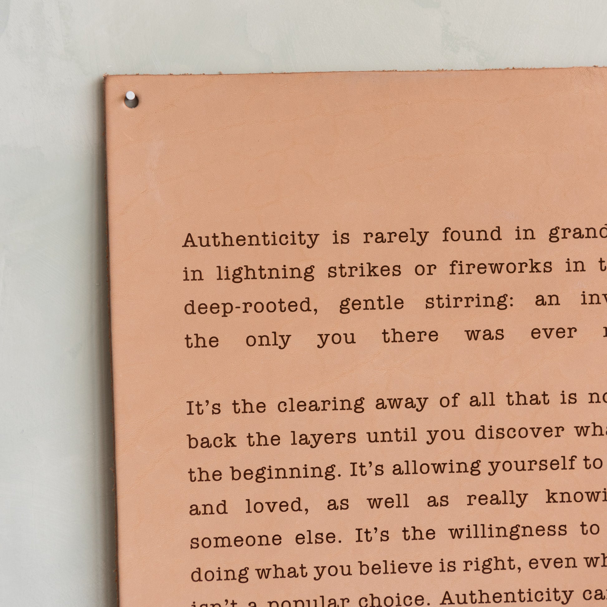 light leather sign with excerpt from magnolia spring 2019 journal about authenticity