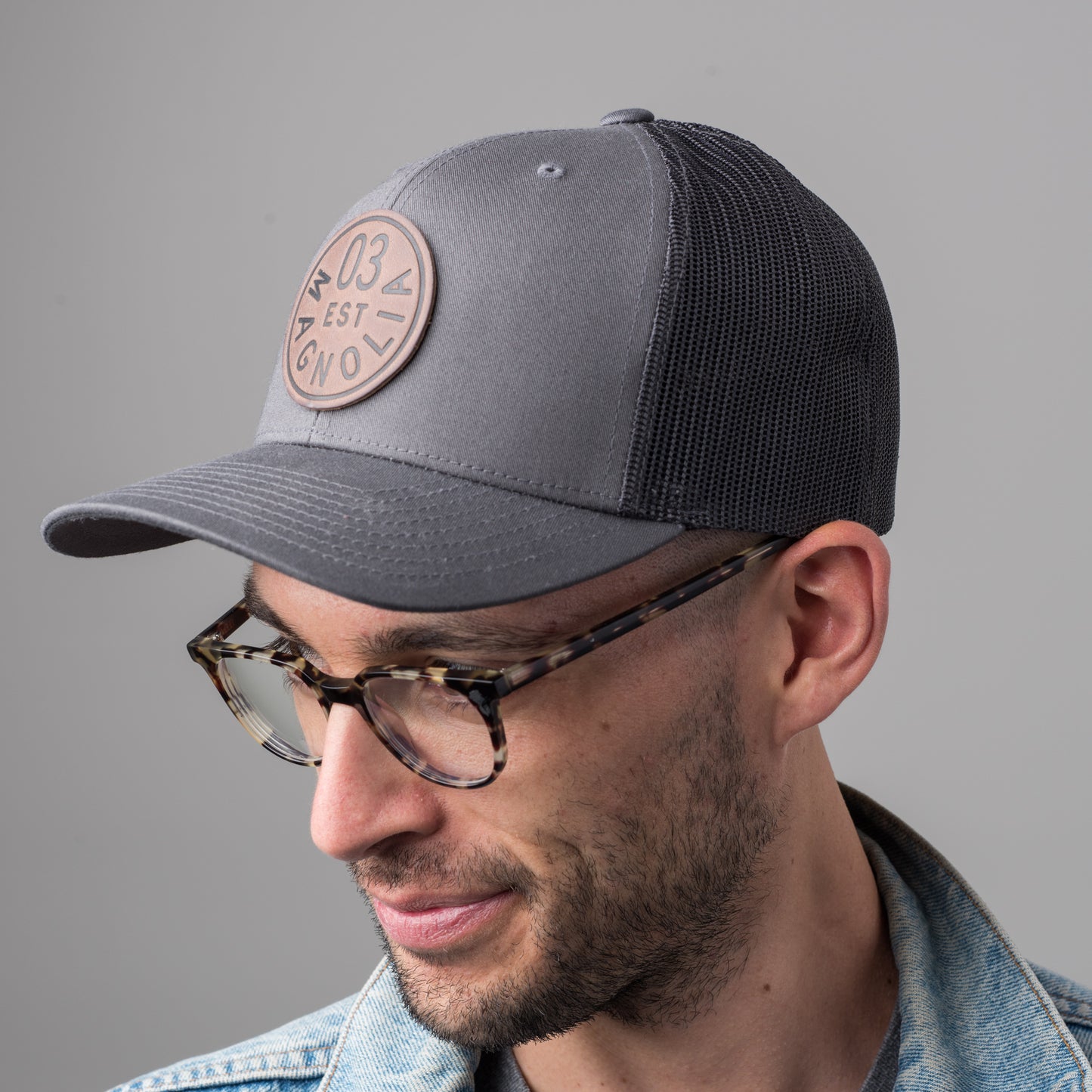 gray magnolia trucker patch with leather logo patch