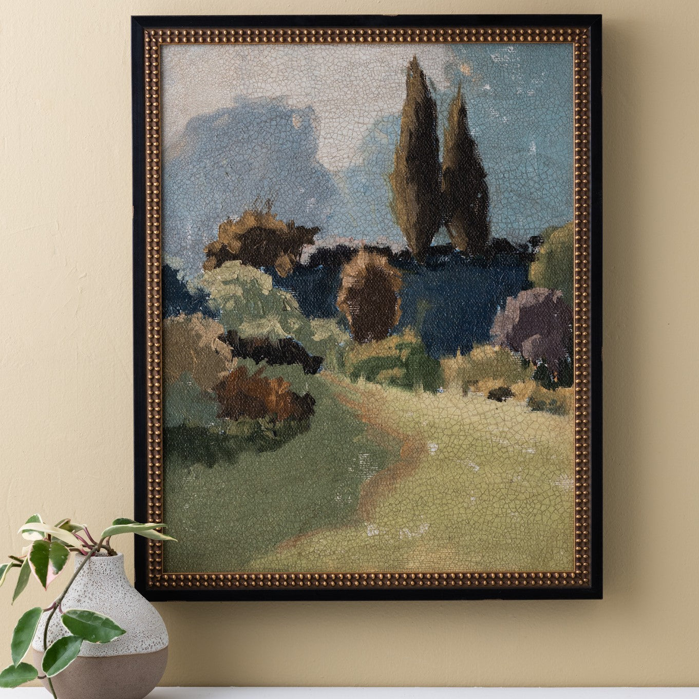 traditionally framed painting of a forest