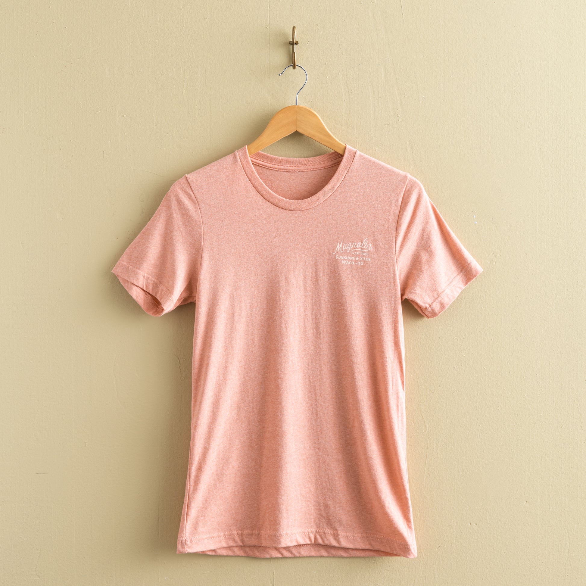 pink-coral t-shirt with "magnolia est 2003" in a cursive script font