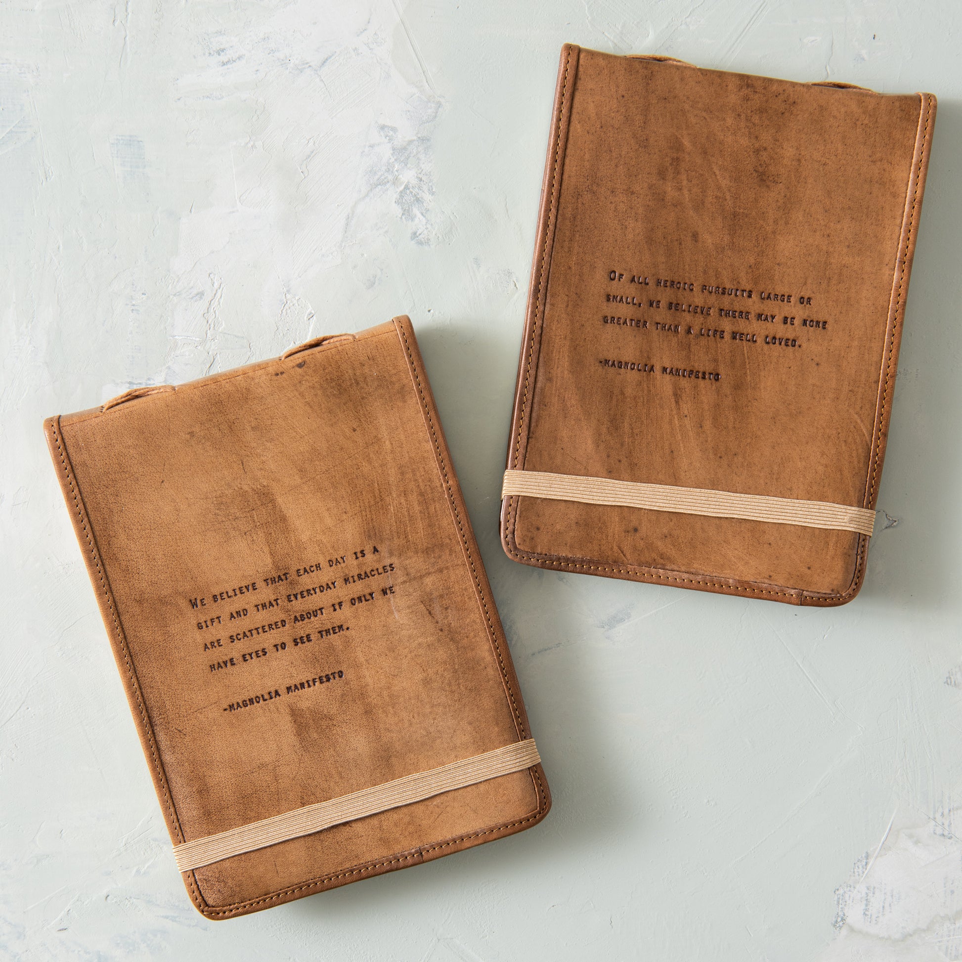 leather journal with excerpt from magnolia manifesto embossed on the cover