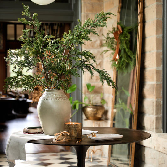 Holiday greenery and golden details give this space a festive feel—ushering in the season in subtle ways.