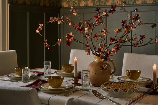 Tablescape with candles and red florals.