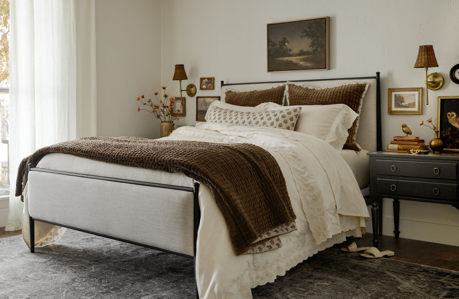 shop bedding. Image features a bed made with quilts and pillows.