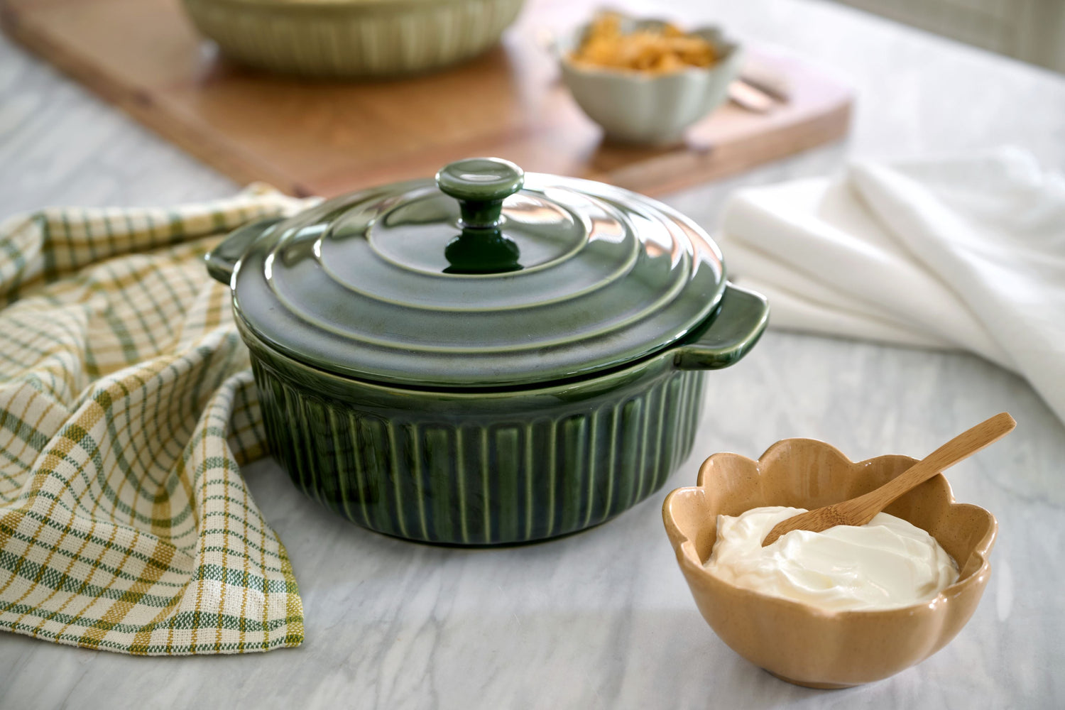 Shop Bakeware Dishes + Pans. Image features a green baking dish with lid.