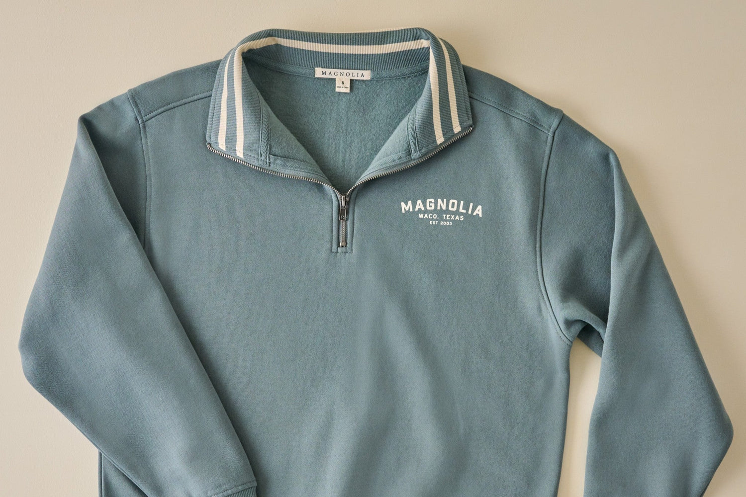 Shop sweatshirts. Image features blue quarter zip sweatshirt.