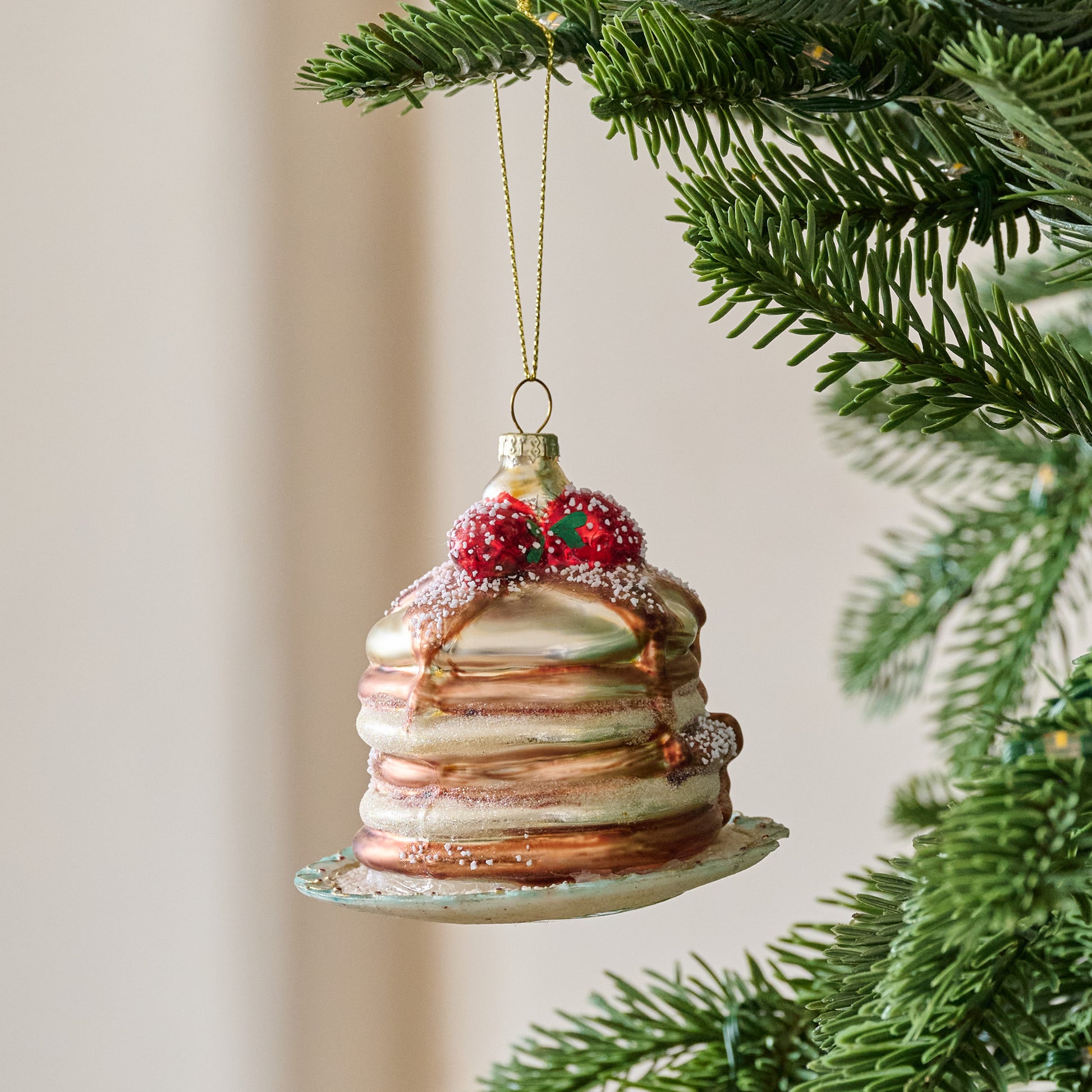 Frosted Pancakes Ornament shown hung from tree
