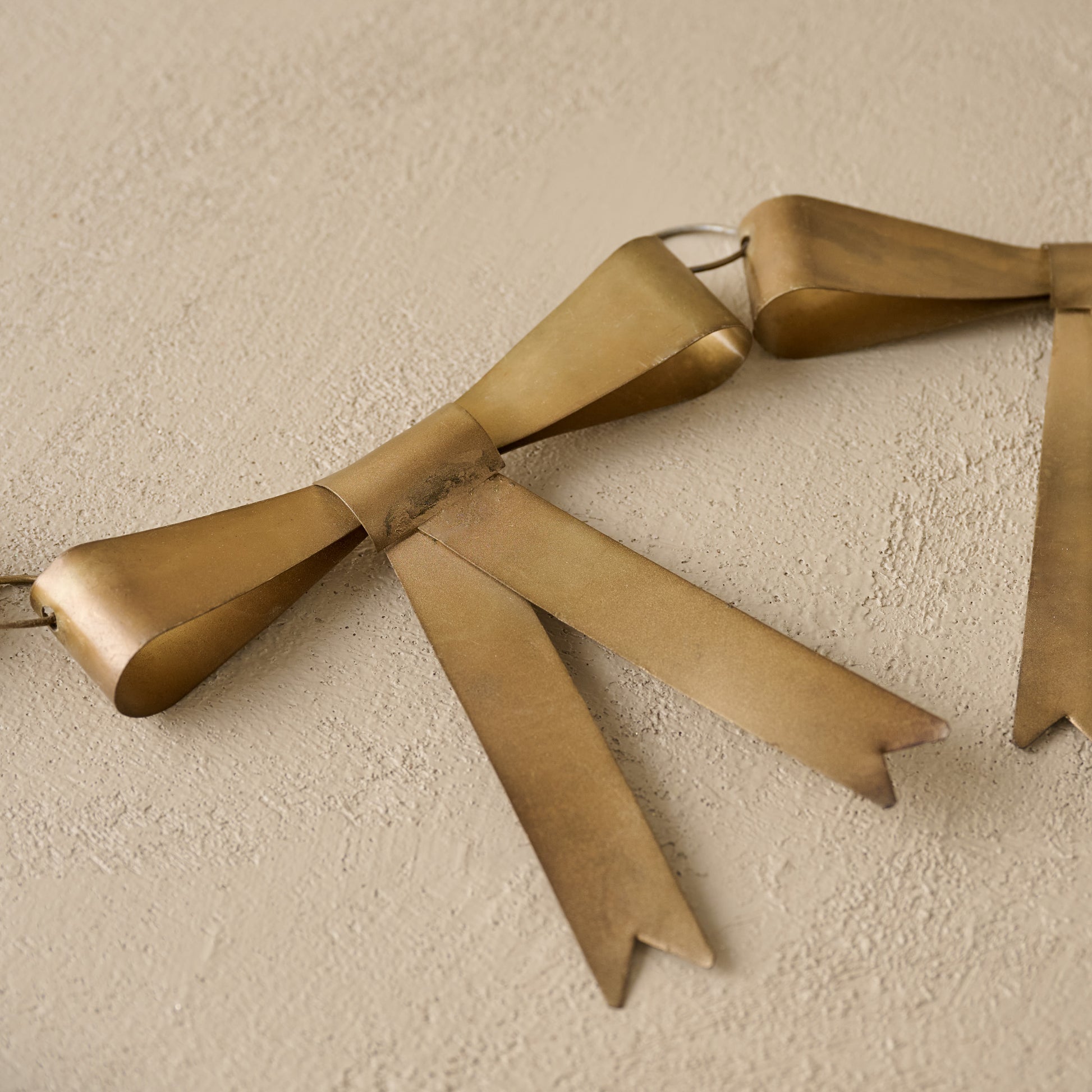 Gloria Brass Bow Garland up close