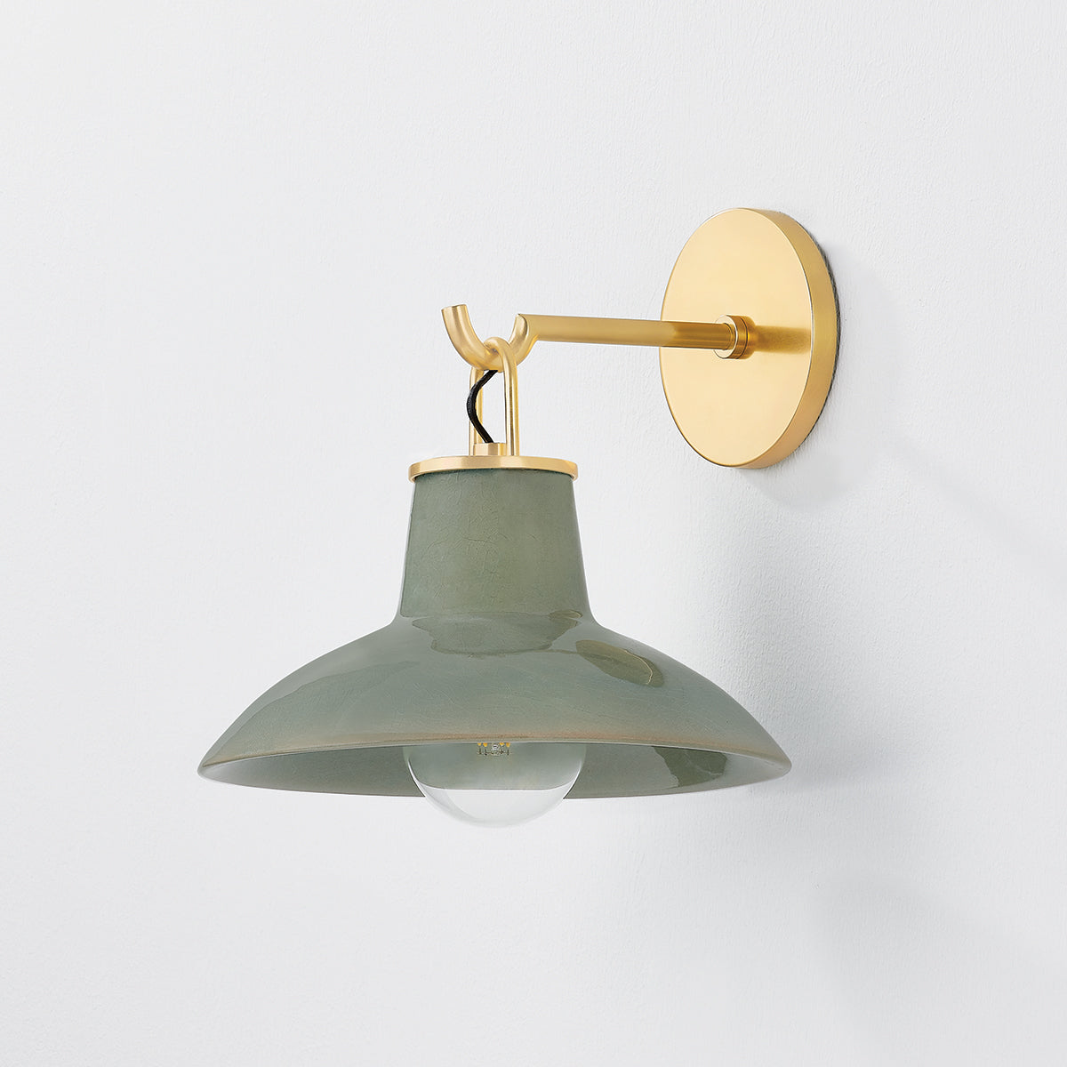 Justine Sconce in color Aged Brass with Ceramic Moss Crackle shown with light off