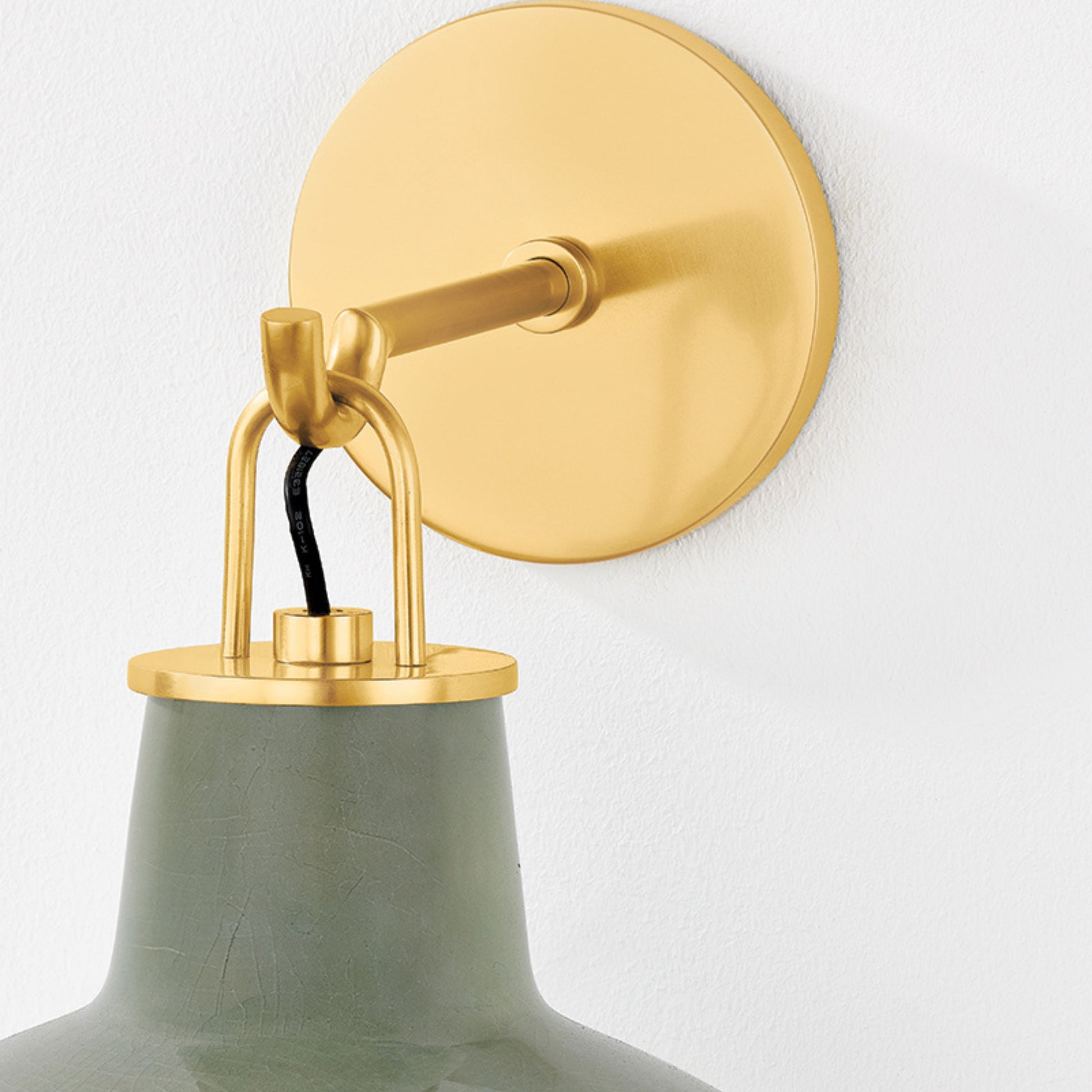 Justine Sconce  in color Aged Brass with Ceramic Moss Crackle  up close