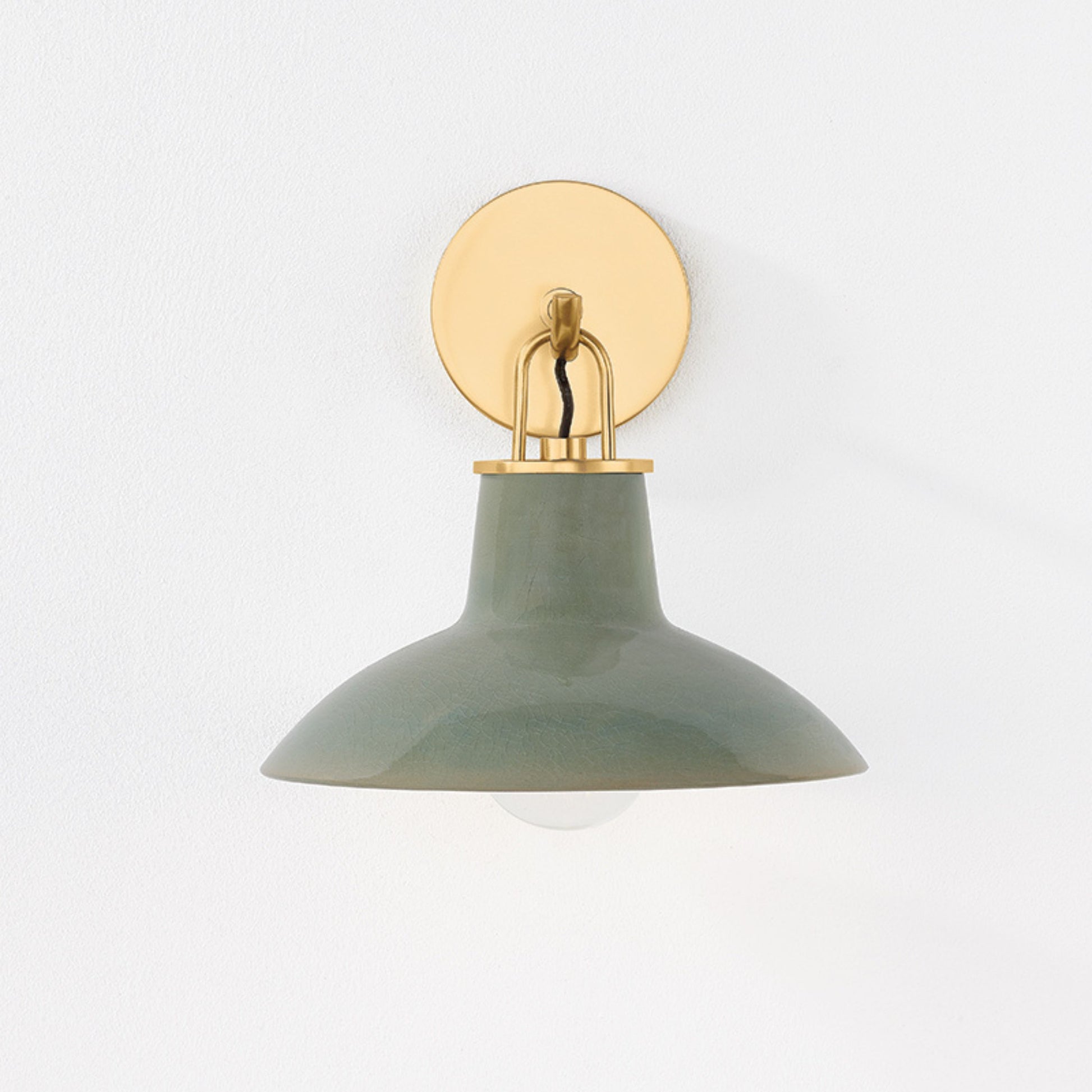 Justine Sconce  in color Aged Brass with Ceramic Moss Crackle  front view