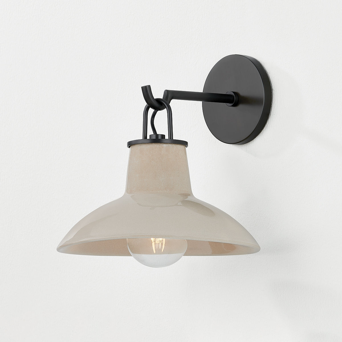 Justine Sconce in color Distressed Black with Ceramic Ivory Crackle shown with light on