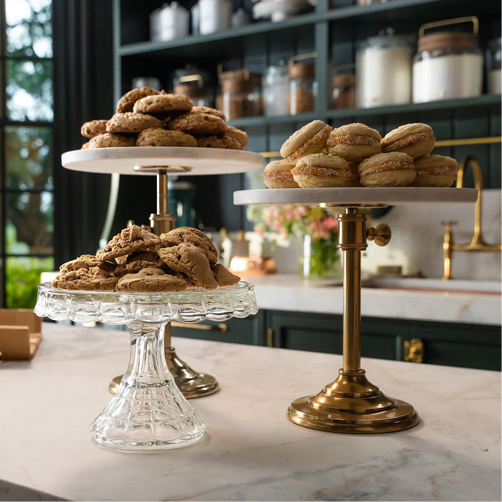 Three tiered cake stands with cookies on a kitchen counter